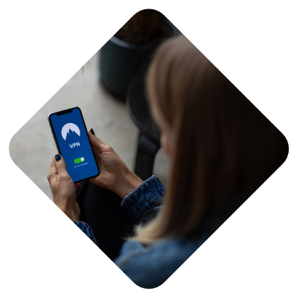 Woman holding a smartphone with a vpn connection screen displayed.