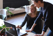 Women Employees Discussing Project on Laptop 